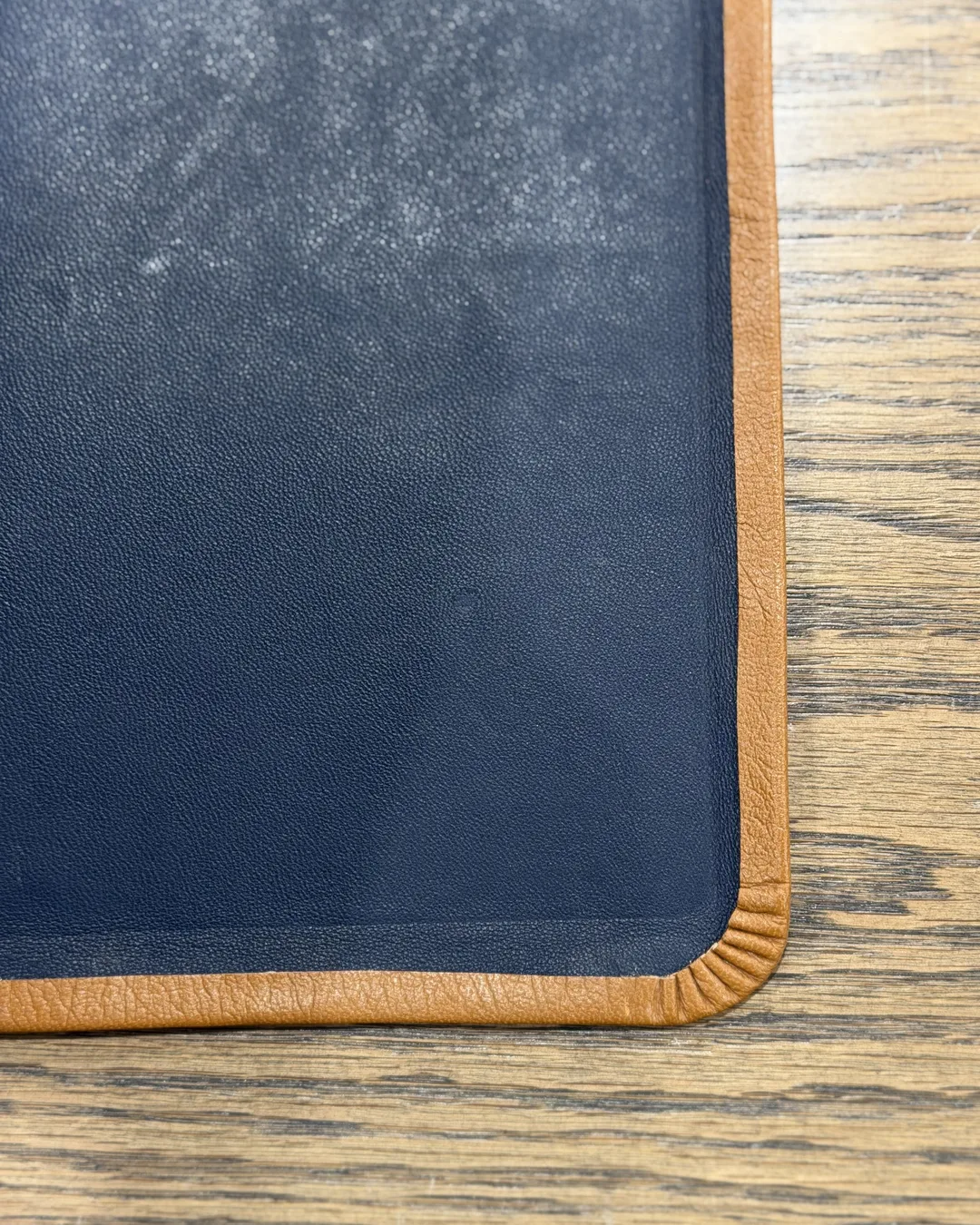 Navy leather cover with contrasting tan edge detail