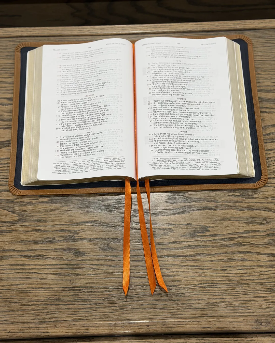 Open Bible with navy leather lining, tan edge and orange ribbons