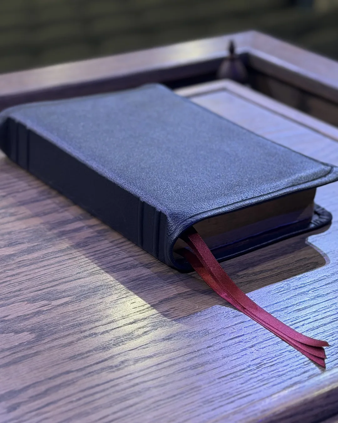 Black leather rebound Bible with red ribbon markers